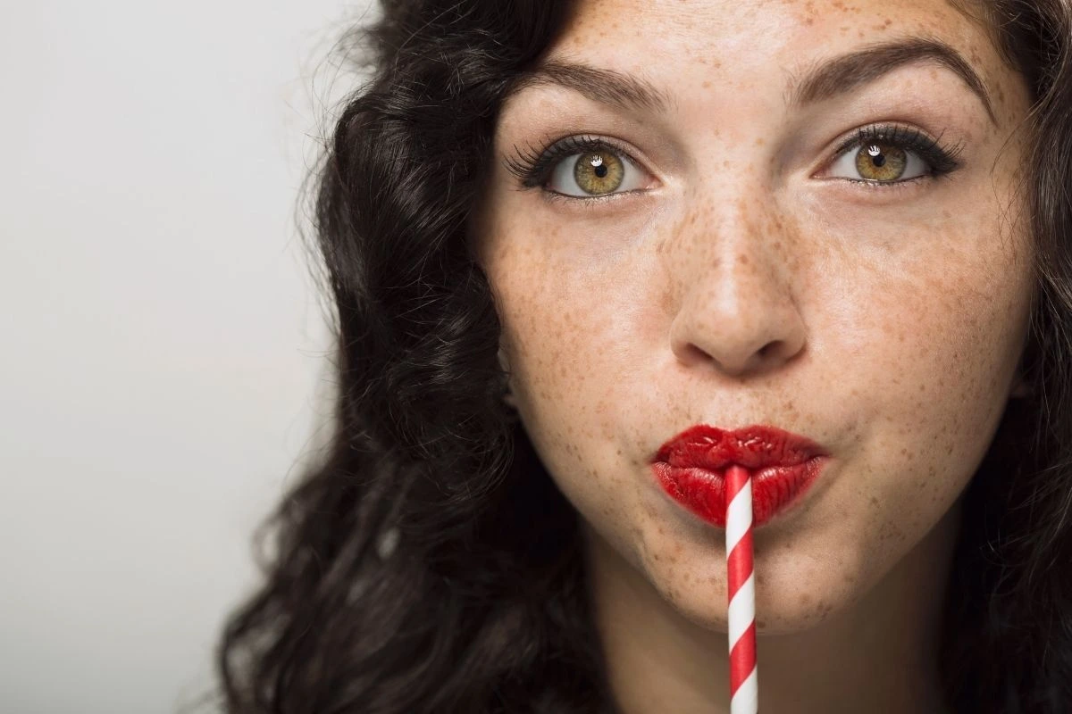Woman drinking from straw