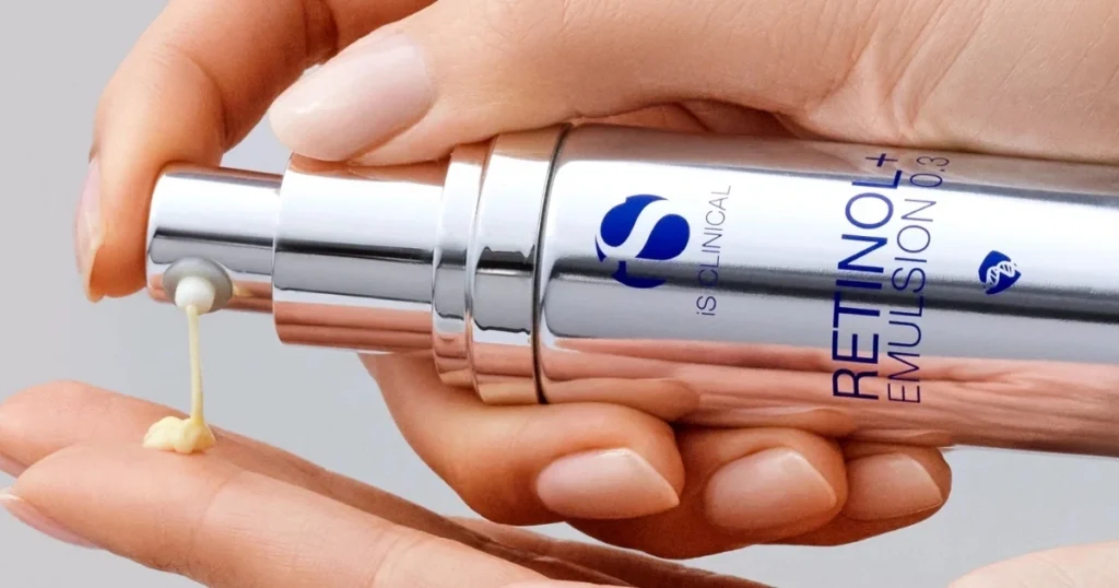 Woman pumping iS Clinical Retinol + Emulsion onto her fingers
