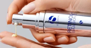 Woman pumping iS Clinical Retinol + Emulsion onto her fingers