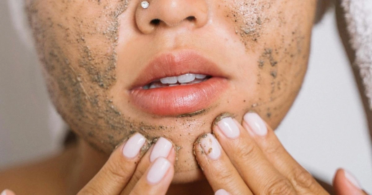 Woman exfoliating her face.