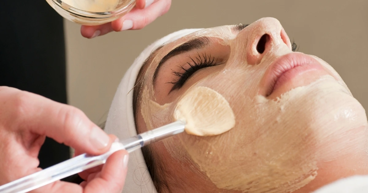 Woman having a mask put on during her facial at Collab Medspa